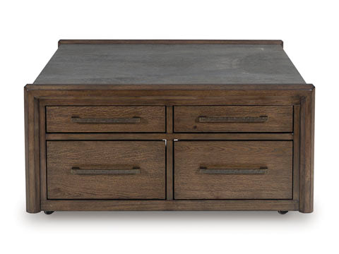 Introducing the Kallenny Cocktail Table T669-8 by Ashley—a wooden coffee table with a dark top surface, four drawers (two on each side) featuring horizontal handles. Its simple, modern design brings a subtle industrial edge to your living space.