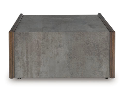 The Kallenny Cocktail Table T669-8 by Ashley features a square, modern design with a gray concrete-like finish and wooden trim on the sides, bringing an industrial edge to your space, set against a white background.