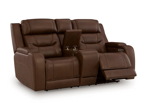 The Ashley Knightington Brown Power Reclining Loveseat (model U1160218A) features a convenient center console with cup holders, making it an ideal addition to your home theater. One seat is shown fully reclined with the footrest extended, emphasizing its comfort and style for cozy movie nights.