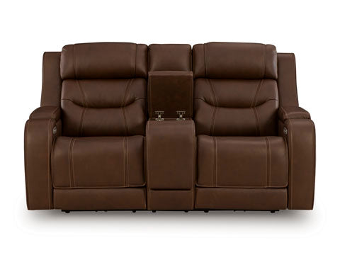 The Ashley Knightington Brown Power Reclining Loveseat U1160218A features plush cushions and a center console with cup holders, making it the perfect home theater sofa, shown against a plain white background.