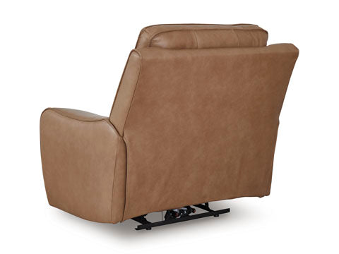 The Ashley DeepWakes Caramel Recliner U6260613 is shown from the back, featuring a top-grain brown leather finish, padded backrest and armrests, and a visible black metal reclining mechanism at the base.