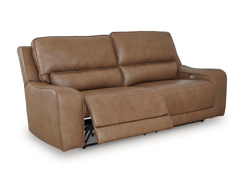 The Ashley DeepWakes Caramel Power Reclining Sofa U6260647 features padded armrests and two seat cushions, with one cushion shown in a reclined position. Upholstered in top-grain caramel leather, this sofa delivers both comfort and style to any living space.
