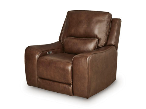 The Ashley DeepWakes Canyon Power Recliner U6260713, upholstered in top grain brown leather, features plush cushions, wide armrests, an adjustable headrest, and a built-in control panel on the side. It is displayed against a plain white background.