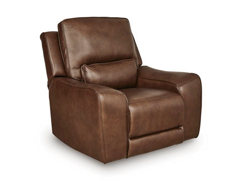 Ashley DeepWakes Canyon Power Recliner U6260713 in brown top grain leather, featuring wide armrests, a cushioned seat, adjustable headrest, and matching lumbar pillow, set against a white background.