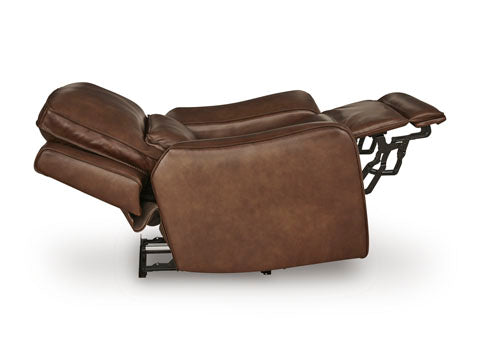 The DeepWakes Canyon Power Recliner U6260713 by Ashley is shown fully extended, upholstered in brown top grain leather with the backrest tilted and the footrest raised, exposing the metal reclining mechanism underneath.