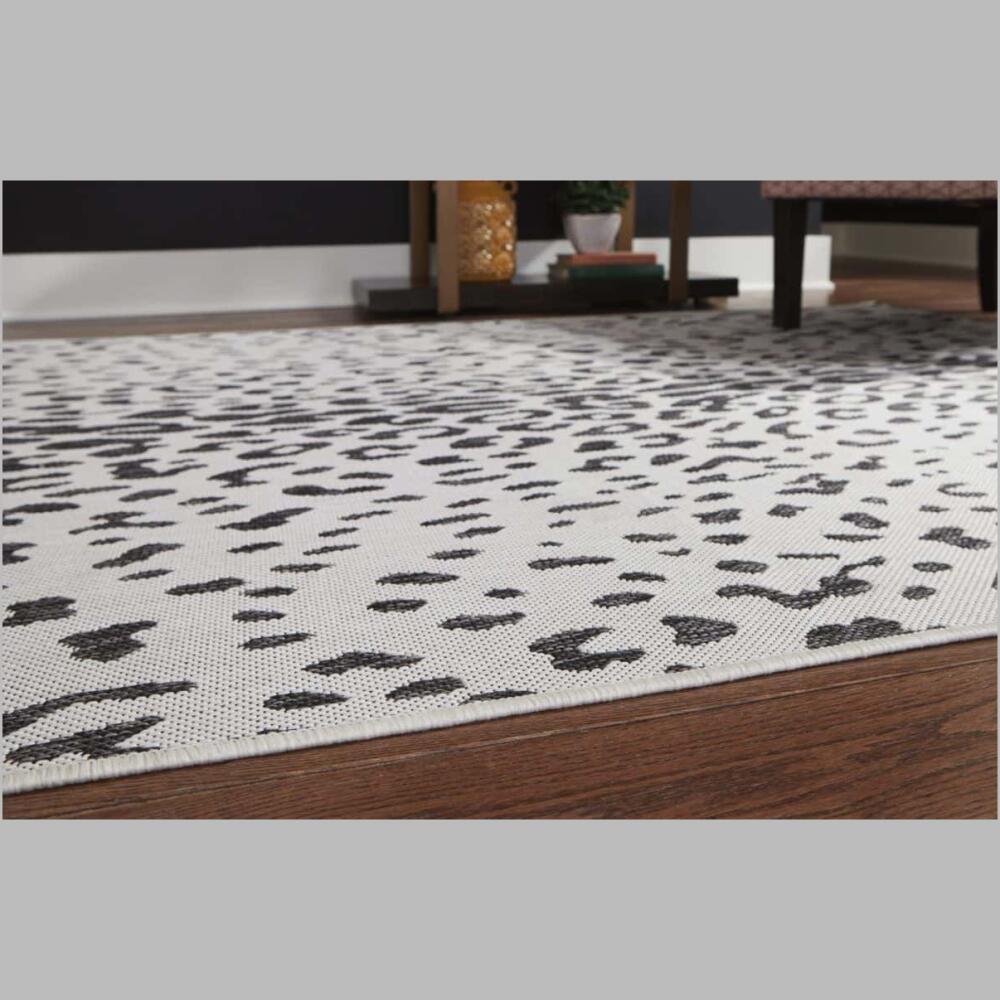 corner of r405021 samya rug go wild with this indoor/outdoor animal print rug, thanks to its black, white and gray color palette.